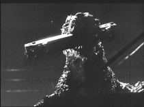 Godzilla with a train car in his mouth